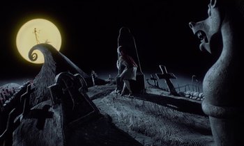 Movie still from “The Nightmare Before Christmas” (1993), directed by Henry Selick – A person standing on top of a hill at night; Extreme Wide shot, High angle