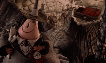 Movie still from “The Nightmare Before Christmas” (1993), directed by Henry Selick – A statue of a person wearing a witch costume; Medium shot, High angle