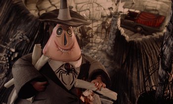 Movie still from “The Nightmare Before Christmas” (1993), directed by Henry Selick – A man in a suit and hat holding a knife; Close Up shot, High angle