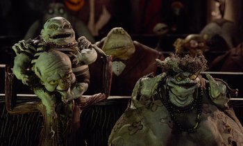 Movie still from “The Nightmare Before Christmas” (1993), directed by Henry Selick – A group of ghouls sitting next to each other in a room; Close Up shot, Low angle