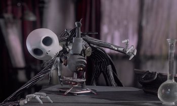 Movie still from “The Nightmare Before Christmas” (1993), directed by Henry Selick – A skeleton is standing in front of a microscope; Medium shot, High angle