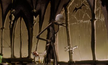 Movie still from “The Nightmare Before Christmas” (1993), directed by Henry Selick – A jack skellington statue; Medium shot, Low angle