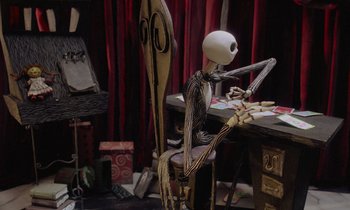 Movie still from “The Nightmare Before Christmas” (1993), directed by Henry Selick – A jack skellington doll sitting in a chair; Medium shot, Over the shoulder angle