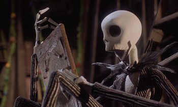 Movie still from “The Nightmare Before Christmas” (1993), directed by Henry Selick – A skeleton sitting in front of an easel; Medium shot, Low angle