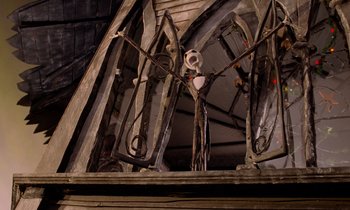 Movie still from “The Nightmare Before Christmas” (1993), directed by Henry Selick – A skeleton is standing in front of a wooden structure; Wide shot, Low angle