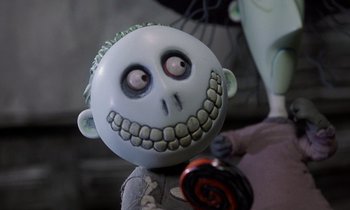 Movie still from “The Nightmare Before Christmas” (1993), directed by Henry Selick – The head of a doll with a creepy face; Close Up shot, Low angle