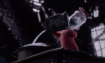 Movie still from “The Nightmare Before Christmas” (1993), directed by Henry Selick – A doll is holding something in its mouth; Medium shot, Low angle