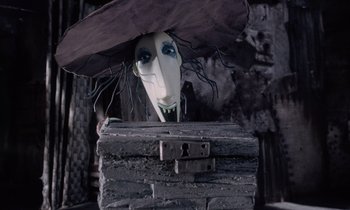 Movie still from “The Nightmare Before Christmas” (1993), directed by Henry Selick – A creepy doll head sitting on top of an old trunk; Close Up shot, Overhead angle
