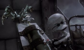 Movie still from “The Nightmare Before Christmas” (1993), directed by Henry Selick – A man in a helmet and a mask is standing next to an object; Medium shot, Low angle