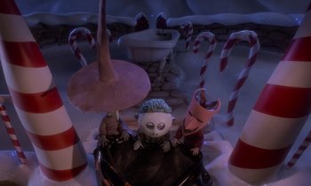 Movie still from “The Nightmare Before Christmas” (1993), directed by Henry Selick – A group of people in a room next to candy canes; Wide shot, High angle