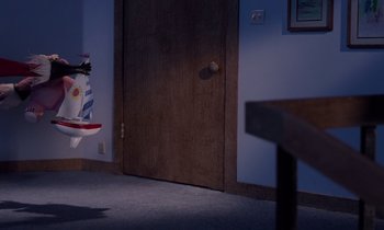 Movie still from “The Nightmare Before Christmas” (1993), directed by Henry Selick – A room that has a door open to a room with a table; Wide shot, High angle