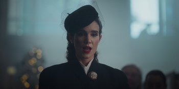 Movie still from “The Noel Diary” (2022), directed by Charles Shyer – A woman wearing a black hat and a black jacket; Close Up shot, Over the shoulder angle