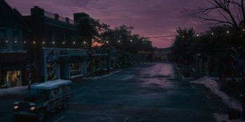 Movie still from “The Noel Diary” (2022), directed by Charles Shyer – A view of an empty parking lot at night; Extreme Wide shot, High angle
