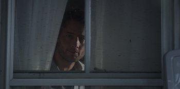 Movie still from “The Noel Diary” (2022), directed by Charles Shyer – A man looking out of a window at night; Close Up shot, Low angle