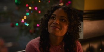 Movie still from “The Noel Diary” (2022), directed by Charles Shyer – A woman sitting in front of a christmas tree; Close Up shot, Over the shoulder angle