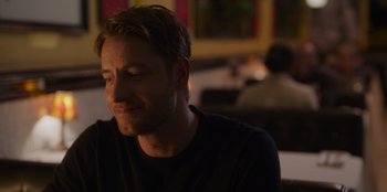 Movie still from “The Noel Diary” (2022), directed by Charles Shyer – A person sitting at a table; Close Up shot, Over the shoulder angle
