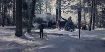 Movie still from “The Noel Diary” (2022), directed by Charles Shyer – A man standing in the middle of a snowy driveway; Extreme Wide shot, High angle