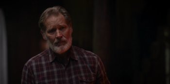 Movie still from “The Noel Diary” (2022), directed by Charles Shyer – An older man with a beard and a plaid shirt; Close Up shot, Over the shoulder angle