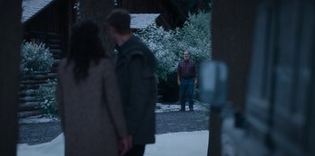 Movie still from “The Noel Diary” (2022), directed by Charles Shyer – A man standing in the middle of a driveway; Wide shot, Over the shoulder angle