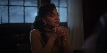 Movie still from “The Noel Diary” (2022), directed by Charles Shyer – A woman in a brown sweater clasps her hands; Medium shot, Over the shoulder angle