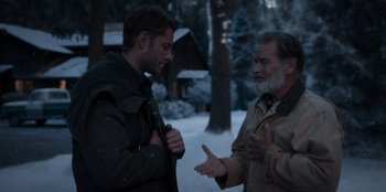 Movie still from “The Noel Diary” (2022), directed by Charles Shyer – Two men are talking in the snow outside; Medium shot, Over the shoulder angle