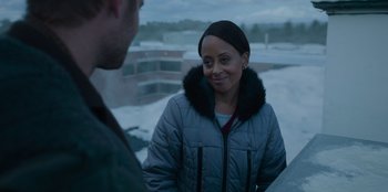 Movie still from “The Noel Diary” (2022), directed by Charles Shyer – A woman in a gray jacket talking to a man; Close Up shot, Over the shoulder angle