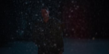 Movie still from “The Noel Diary” (2022), directed by Charles Shyer – A man standing in the snow at night; Medium shot, Low angle