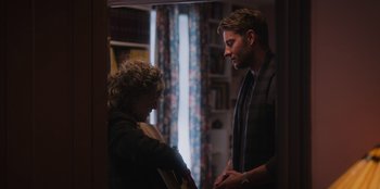 Movie still from “The Noel Diary” (2022), directed by Charles Shyer – A man and a woman standing next to each other in a room; Medium shot, Over the shoulder angle