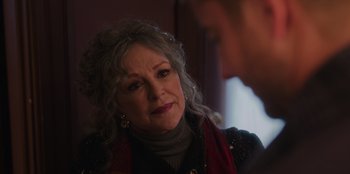 Movie still from “The Noel Diary” (2022), directed by Charles Shyer – An older woman is sitting in front of a man; Close Up shot, Over the shoulder angle