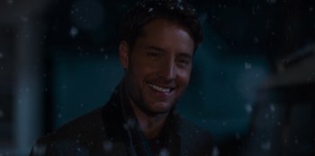 Movie still from “The Noel Diary” (2022), directed by Charles Shyer – A person smiling in the snow; Close Up shot, Over the shoulder angle