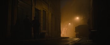 Movie still from “The Nun II” (2023), directed by Michael Chaves – A person standing on a street at night; Extreme Wide shot, Low angle