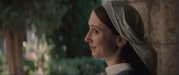 Movie still from “The Nun II” (2023), directed by Michael Chaves – A woman with a head scarf looking to her left; Close Up shot, Low angle
