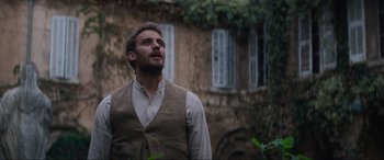 Movie still from “The Nun II” (2023), directed by Michael Chaves – A man standing in front of an old building; Medium shot, Low angle