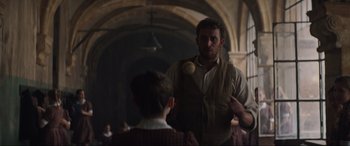 Movie still from “The Nun II” (2023), directed by Michael Chaves – A man holding a baseball bat near a young boy; Medium shot, Over the shoulder angle