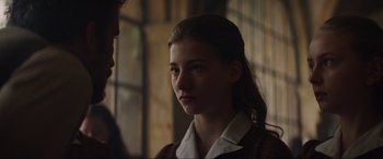 Movie still from “The Nun II” (2023), directed by Michael Chaves – A young girl is looking at a man; Close Up shot, Over the shoulder angle