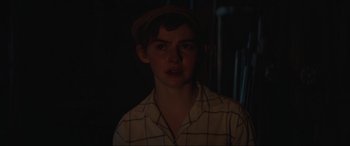 Movie still from “The Nun II” (2023), directed by Michael Chaves – A young man wearing a brown hat and a plaid shirt; Close Up shot, Over the shoulder angle