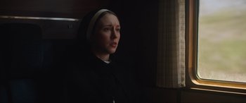 Movie still from “The Nun II” (2023), directed by Michael Chaves – A woman wearing a nun's habit looking at the camera; Close Up shot, Low angle