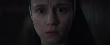 Movie still from “The Nun II” (2023), directed by Michael Chaves – A woman's face in the dark; Close Up shot, Overhead angle