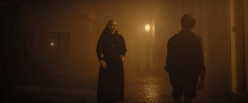 Movie still from “The Nun II” (2023), directed by Michael Chaves – A woman dressed as a nun standing in the fog; Wide shot, Low angle