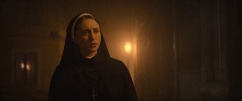 Movie still from “The Nun II” (2023), directed by Michael Chaves – A woman wearing a nun's habit with a cross on her head; Close Up shot, Low angle