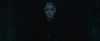 Movie still from “The Nun II” (2023), directed by Michael Chaves – A woman wearing a nun's outfit in the dark; Close Up shot, Low angle