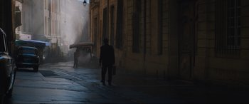 Movie still from “The Nun II” (2023), directed by Michael Chaves – A man walking down a street holding a briefcase; Extreme Wide shot, High angle