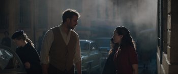 Movie still from “The Nun II” (2023), directed by Michael Chaves – A man and a woman standing next to each other on the street; Medium shot, Over the shoulder angle