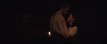Movie still from “The Nun II” (2023), directed by Michael Chaves – A man and a woman standing next to each other in the dark; Medium shot, Low angle