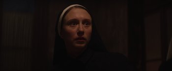Movie still from “The Nun II” (2023), directed by Michael Chaves – A woman wearing a nun's habit looking up at the sky; Close Up shot, Low angle