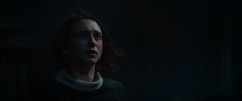 Movie still from “The Nun II” (2023), directed by Michael Chaves – A woman is looking into the distance in the dark; Close Up shot, Low angle