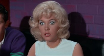 Movie still from “The Nutty Professor” (1963), directed by Jerry Lewis – A woman with a surprised look on her face; Close Up shot, Low angle