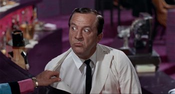 Movie still from “The Nutty Professor” (1963), directed by Jerry Lewis – An older man wearing a white dress shirt and black tie; Close Up shot, Over the shoulder angle