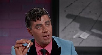 Movie still from “The Nutty Professor” (1963), directed by Jerry Lewis – A person wearing a suit and tie; Close Up shot, Over the shoulder angle