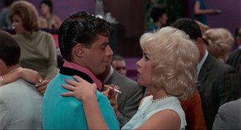 Movie still from “The Nutty Professor” (1963), directed by Jerry Lewis – A man and a woman are dancing together; Medium shot, Over the shoulder angle